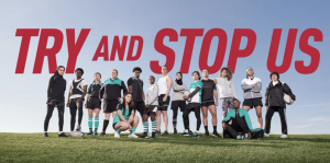 Diverse group of female rugby players with the slogan "TRY AND STOP US" in the background.