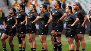 women's rugby team lined up on the field with determination