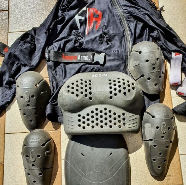 damaged fempro armour body armor and jersey after a motorcycle accident displaying chafe marks and tears